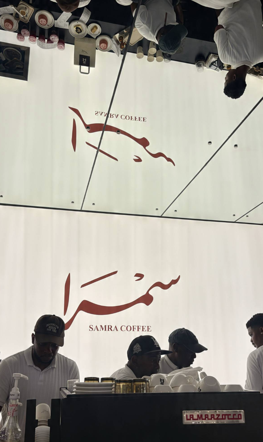 Samra Coffee logo wall above the espresso bar