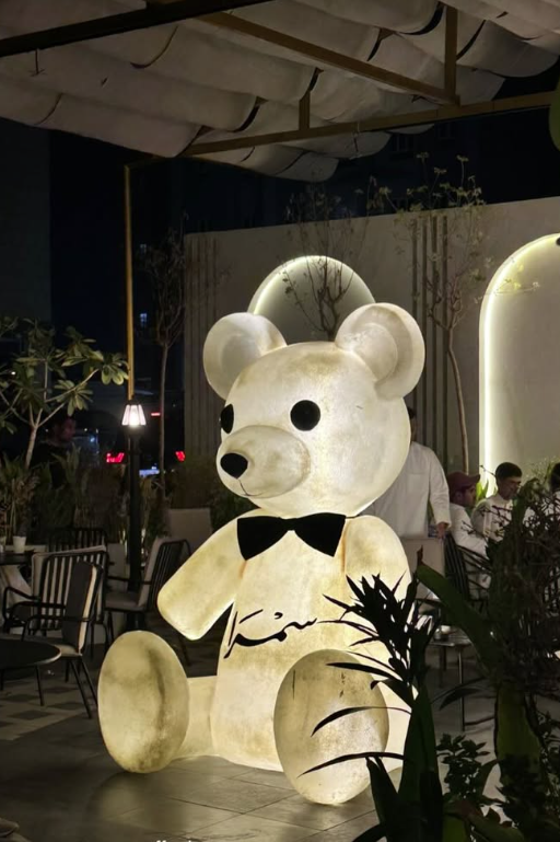 Illuminated bear in the Samra terrace at night